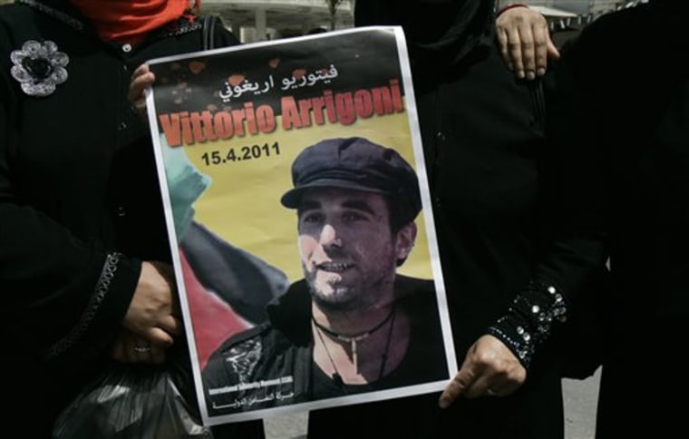 Palestinian women hold a banner with the picture of Italian activist Vittorio Arrigoni during a protest in the West Bank city of Nablus, Saturday, April 16, 2011. A Hamas official says two suspects have been arrested in connection with the abduction and murder of an Italian activist in the Palestinian territory.Vittorio Arrigoni was kidnapped by members of a small extremist group on Thursday. Hamas forces found his body Friday.(AP Photo/Nasser Ishtayeh)